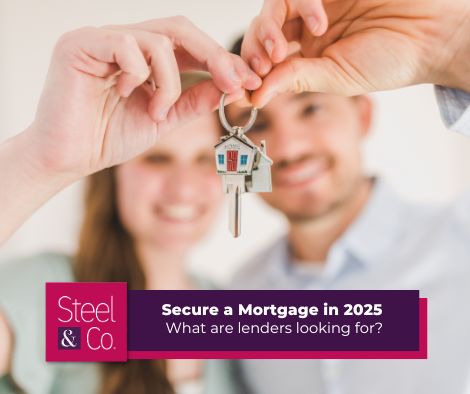 A couple holding the keys to their new home after successfully obtaining a mortgage 
